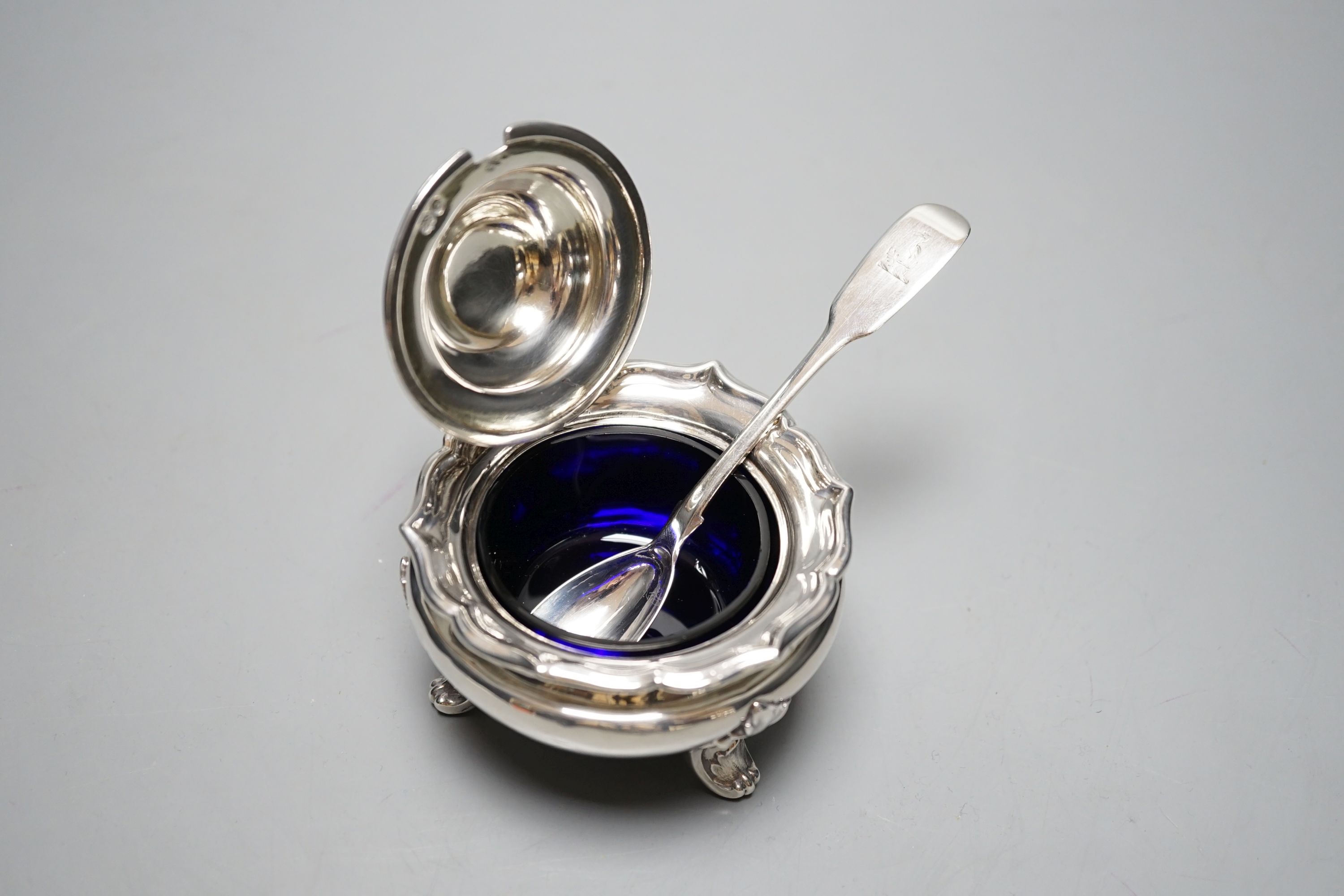 A late William IV silver circular mustard pot, with blue glass liner, The Barnards, London, 1837, with earlier associated fiddle pattern mustard spoon.